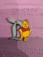 This is a picture showing DLR Winnie The Pooh Disneyland D Characters Hidden Disney 2020 Disney Pin (D1)