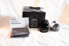 This is a picture showing Fujinon XF23mm F1.4 R Lens|Hood|Cap|Box Mint Glass