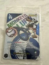 This is a picture showing 2025 DODGERS X ONE PIECE MONKEY D LUFFY PROMO CARD SEALED Crease Top Right SGA