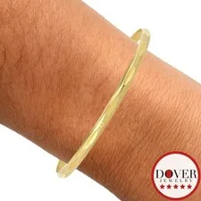 This is a picture showing Estate 17K Yellow Gold 7.75" Textured Stacking Bangle Bracelet 9.8 Grams NR