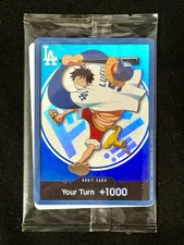 This is a picture showing 2026 Dodgers X One Piece Night Promo Card Monkey D Luffy In Hand
