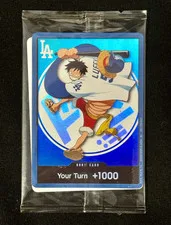 This is a picture showing 2026 Dodgers X One Piece Night Promo Card Monkey D Luffy In Hand