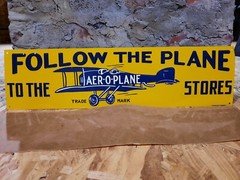 NEW OLD STOCK NOS EMBOSSED FOLLOW THE PLANE TO THE STORES AER-O-PLANE METAL SIGN
