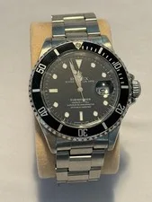 This is a picture showing ROLEX MENS SUBMARINER DATE 16610 OYSTER SS 40MM BLACK DIAL AUTOMATIC WATCH 1991