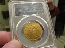 This is a picture showing GOLD -PCGS GRADED 1907 LIBERTY HEAD EAGLE  MS-62  ROOSEVELT LEGACY HOLDER 1/2 OZ