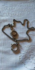 Victorian-Edwardian pocket watch chain with ornate charm and swivel fob 